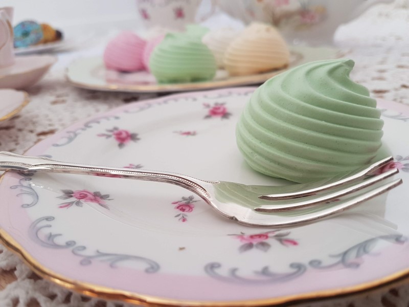green meringe and cake fork on a vintage china plate with pink edging